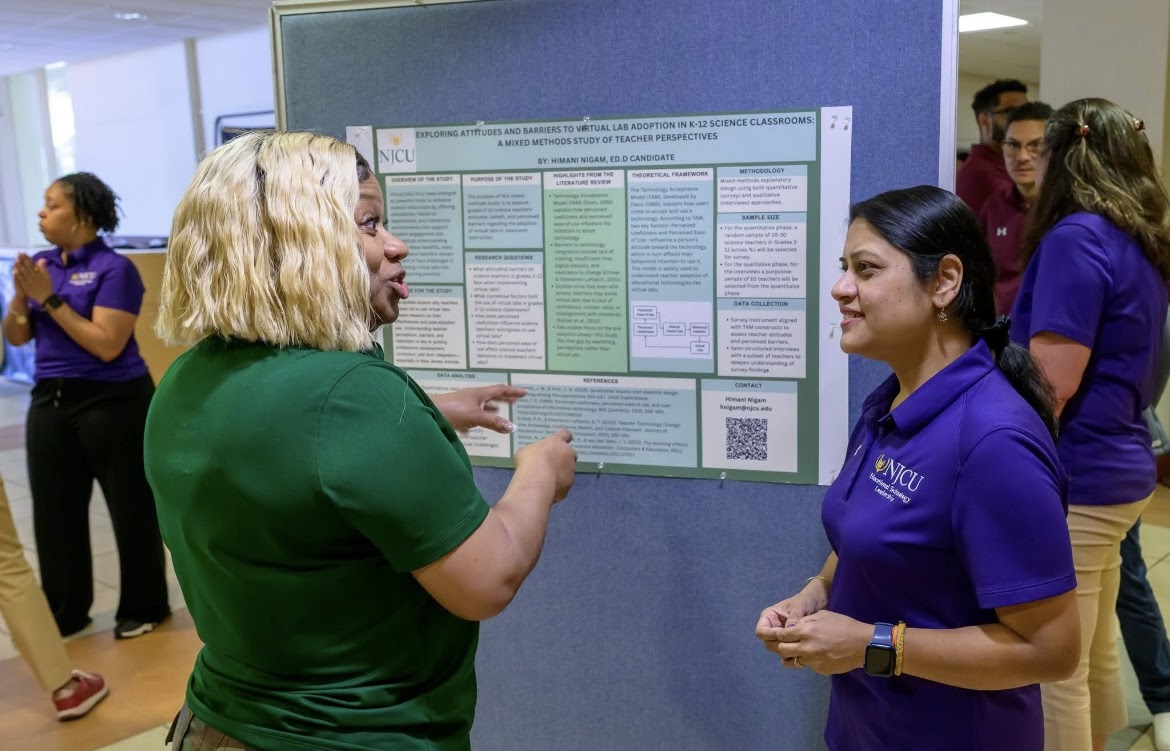 Elizabeth Elie discussing doctoral research at an NJCU poster session